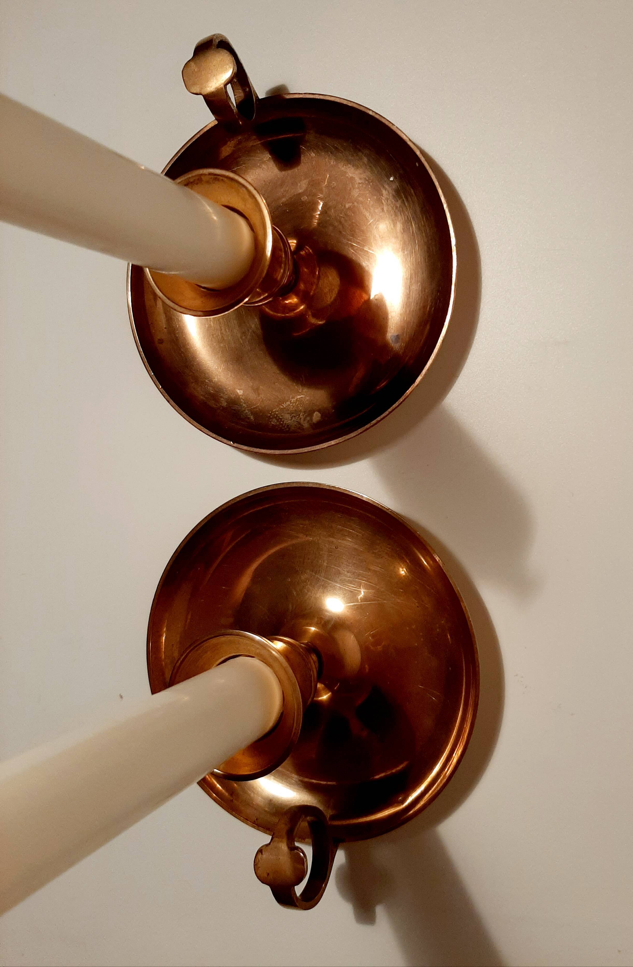 Pair of brass hand candlesticks