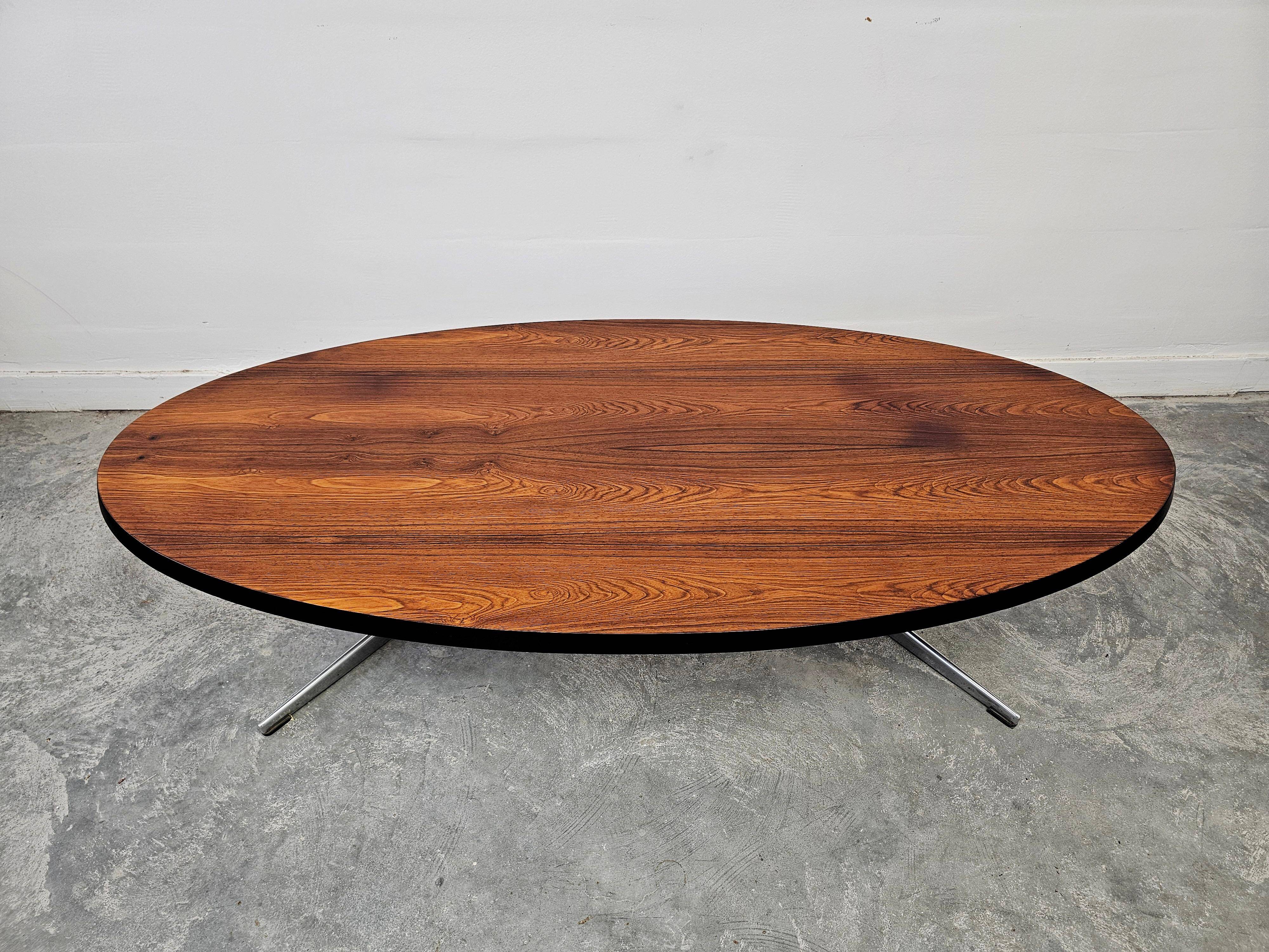 Danish Mid Century Modern oval coffee table with a teak top and chrome legs.