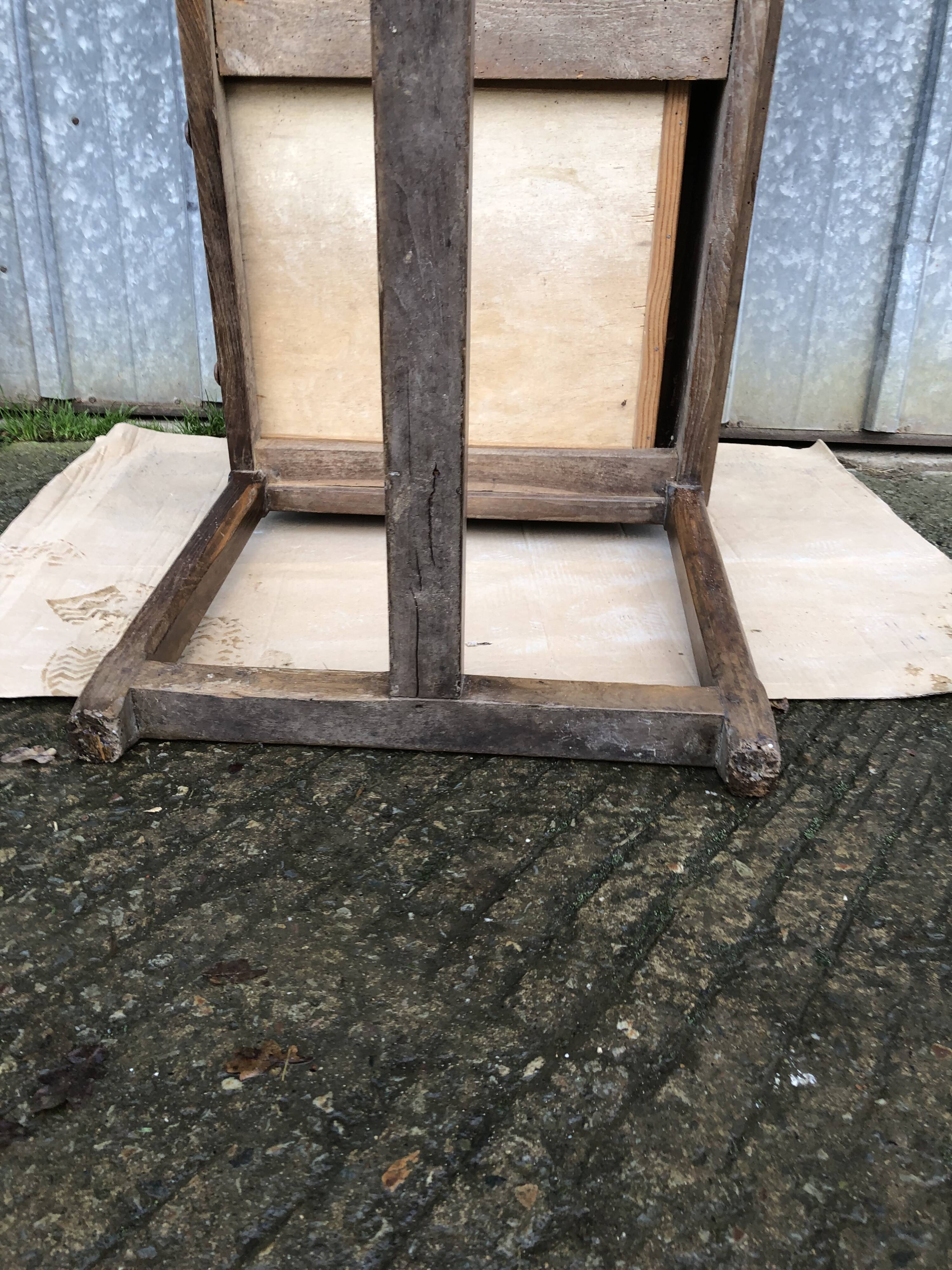 Old chestnut table with 3 front drawers and a cat bar.