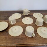 5 enameled stoneware cups and saucers