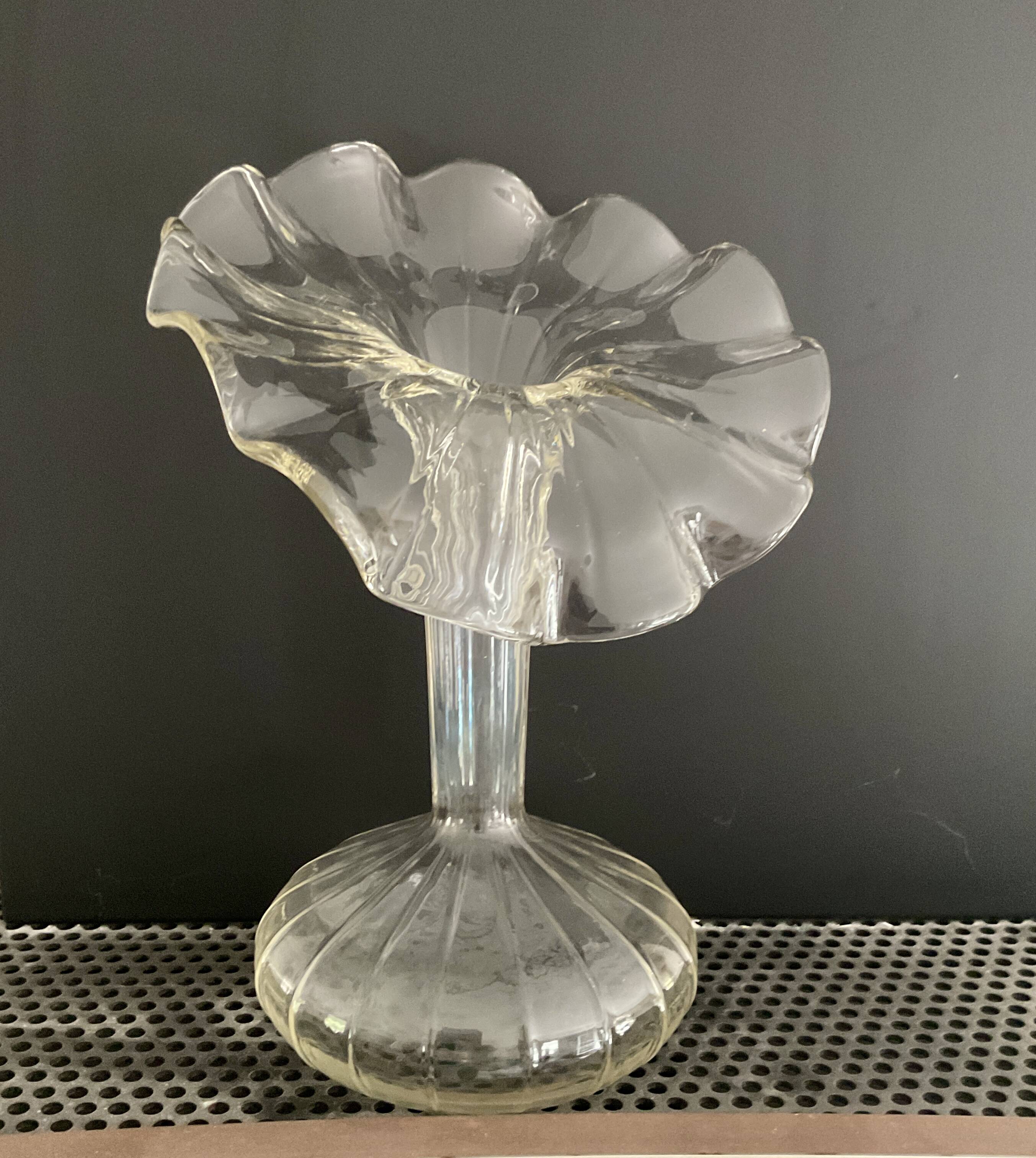 Vintage transparent glass vase in flower shape.