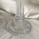 Column candle holders in moulded glass made in France.
