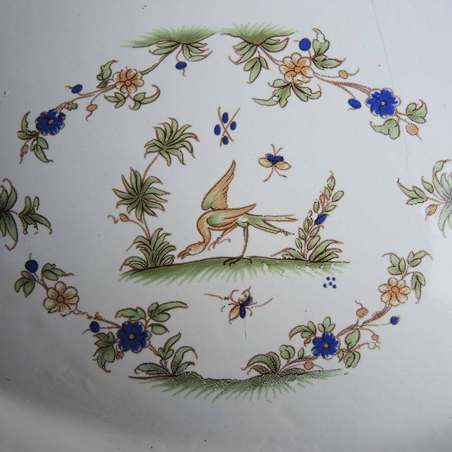 Old large oval serving dish in Moustiers earthenware.