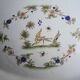 Old large oval serving dish in Moustiers earthenware.
