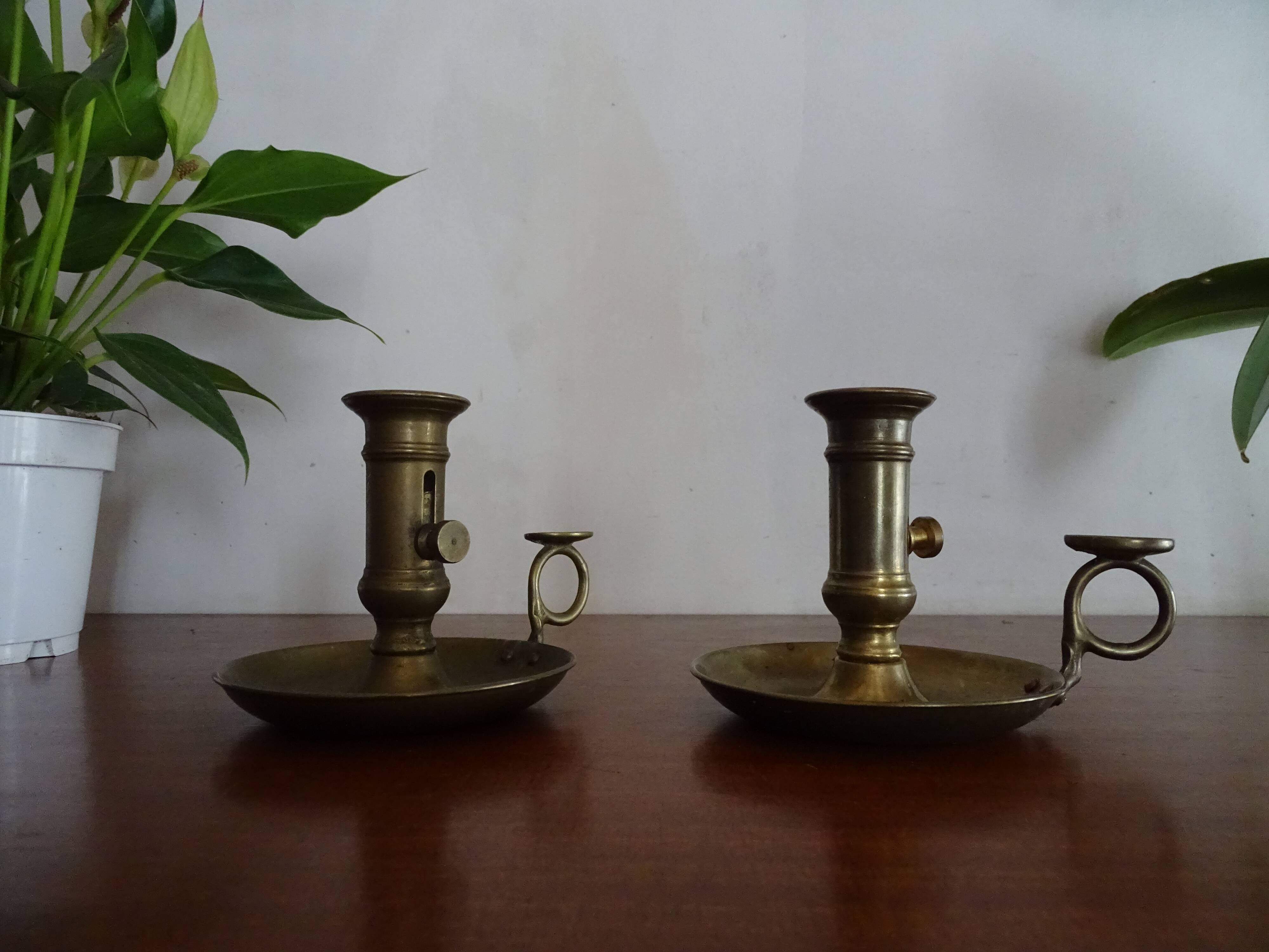 Pair of vintage brass pusher candle holders