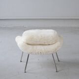 Womb Chair and Ottoman in fluffy white fabric by Eero Saarinen