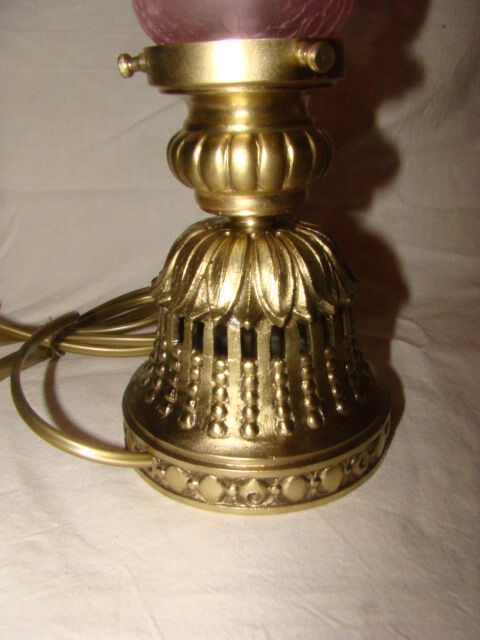 bronze bedside lamp with a pink cracked glass shade