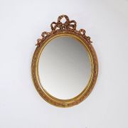 Wear consistent with age and use Wood and gilded plaster "Noeud d'Amour" Oval mirror