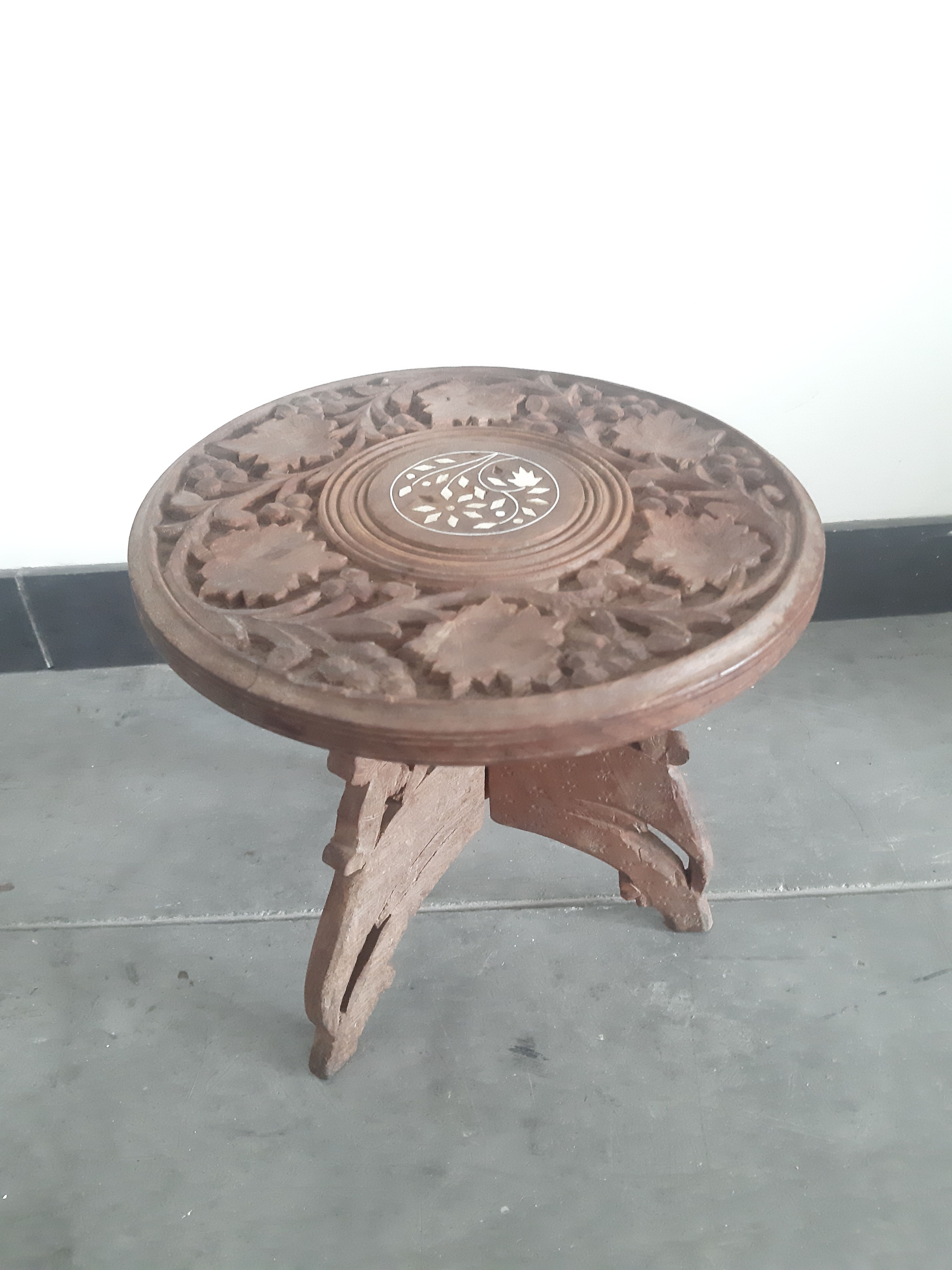 Carved wooden hunting stool decorated with vines