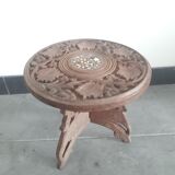 Carved wooden hunting stool decorated with vines