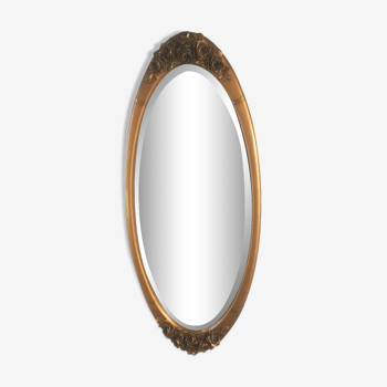 Oval beveled art deco mirror in gilded stucco