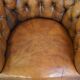 Antique, characteristic sheepskin chesterfield club chair on wheels