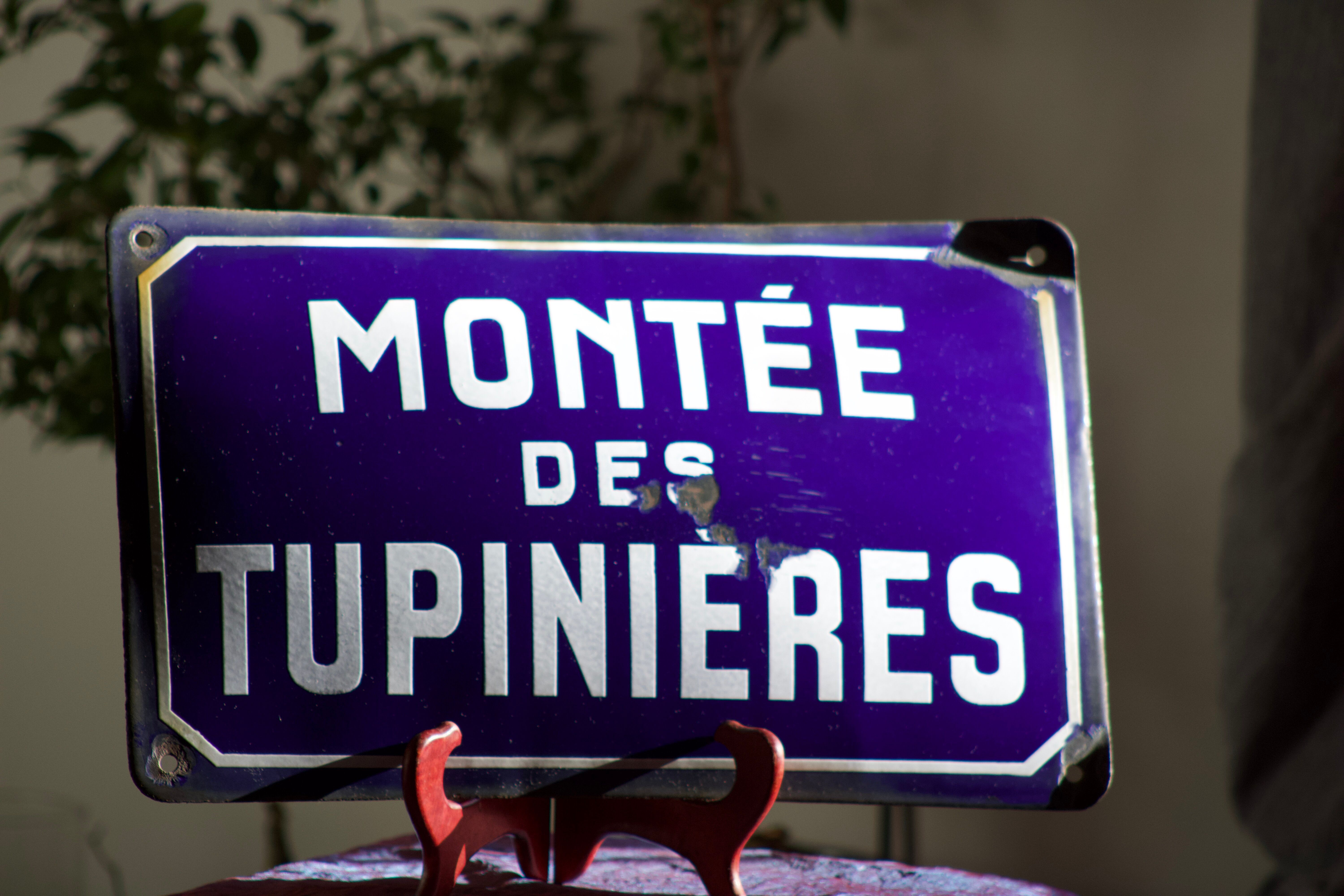Former French street name plaque in bulging enamel led sheet "Montée des Tupinieres"
