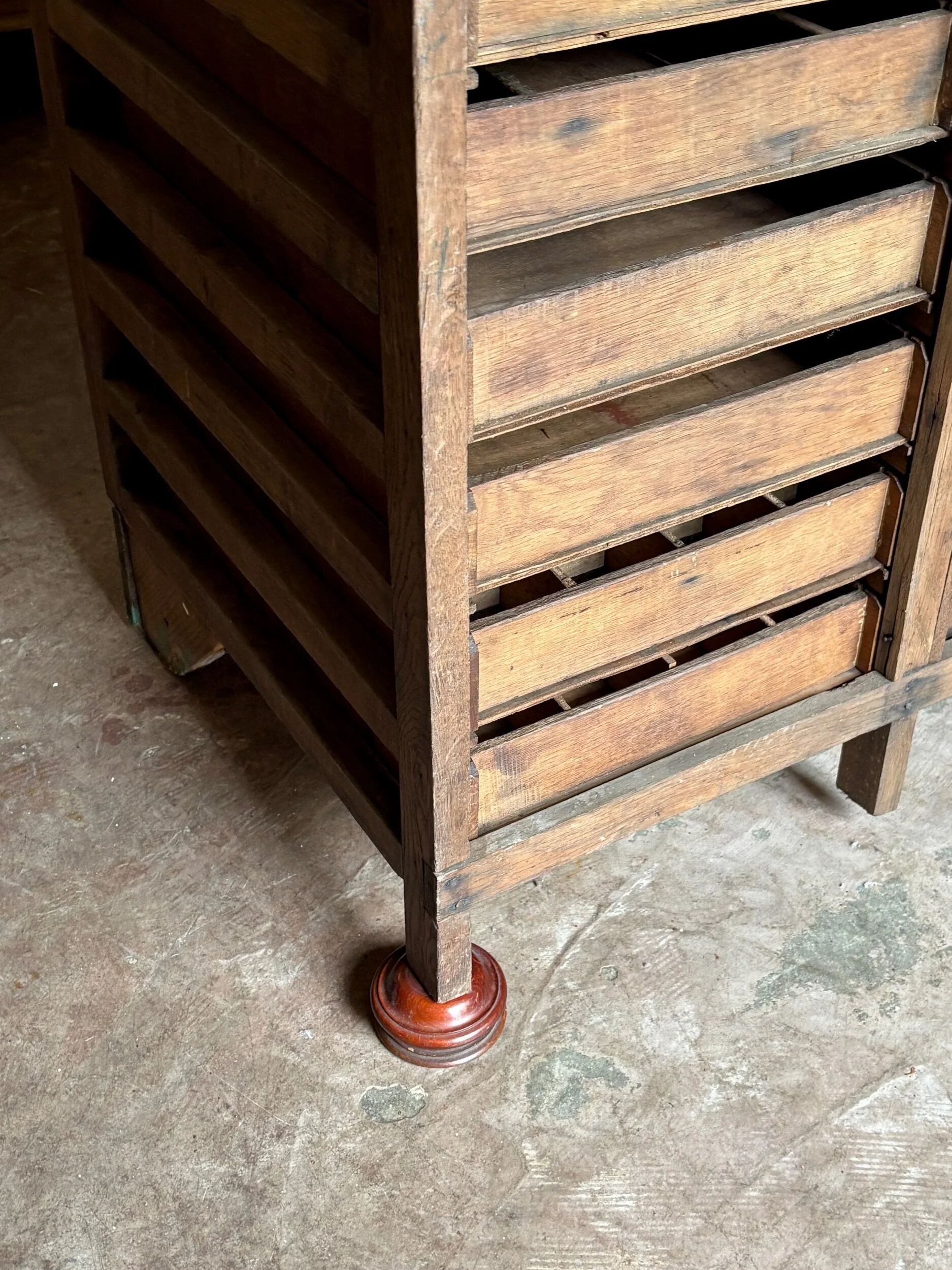 Craftsman's cabinet with 16 drawers in dark wood.