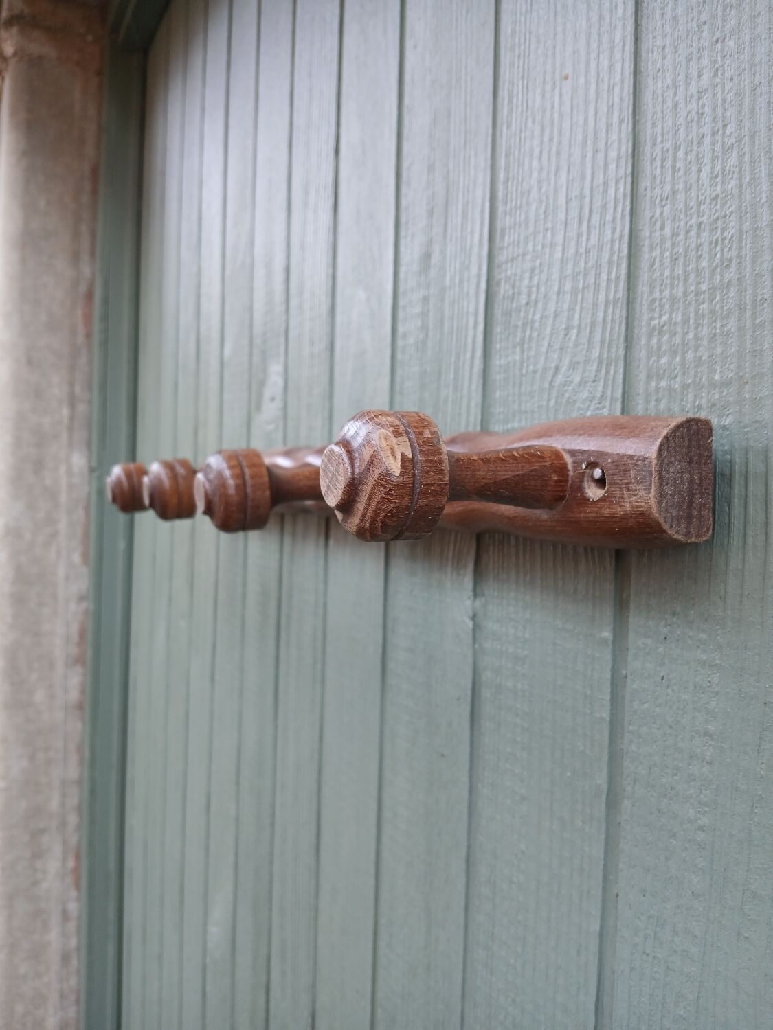 Small antique wooden wall coat rack.