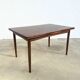 Rosewood dining table with integrated extensions — Denmark, 1960s