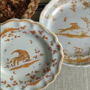Pair of antique plates with a bird of paradise design in the style of Moustiers.