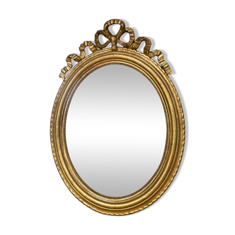 Oval mirror with pediment and pearl gilded with gold leaf 106cm/76.5cm