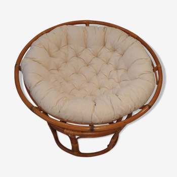 Rattan swivel chair and linen cushion