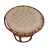 Rattan swivel chair and linen cushion