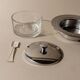 Vintage 1970s condiment pot made of glass and stainless steel with a lid, complete with a matching spoon.