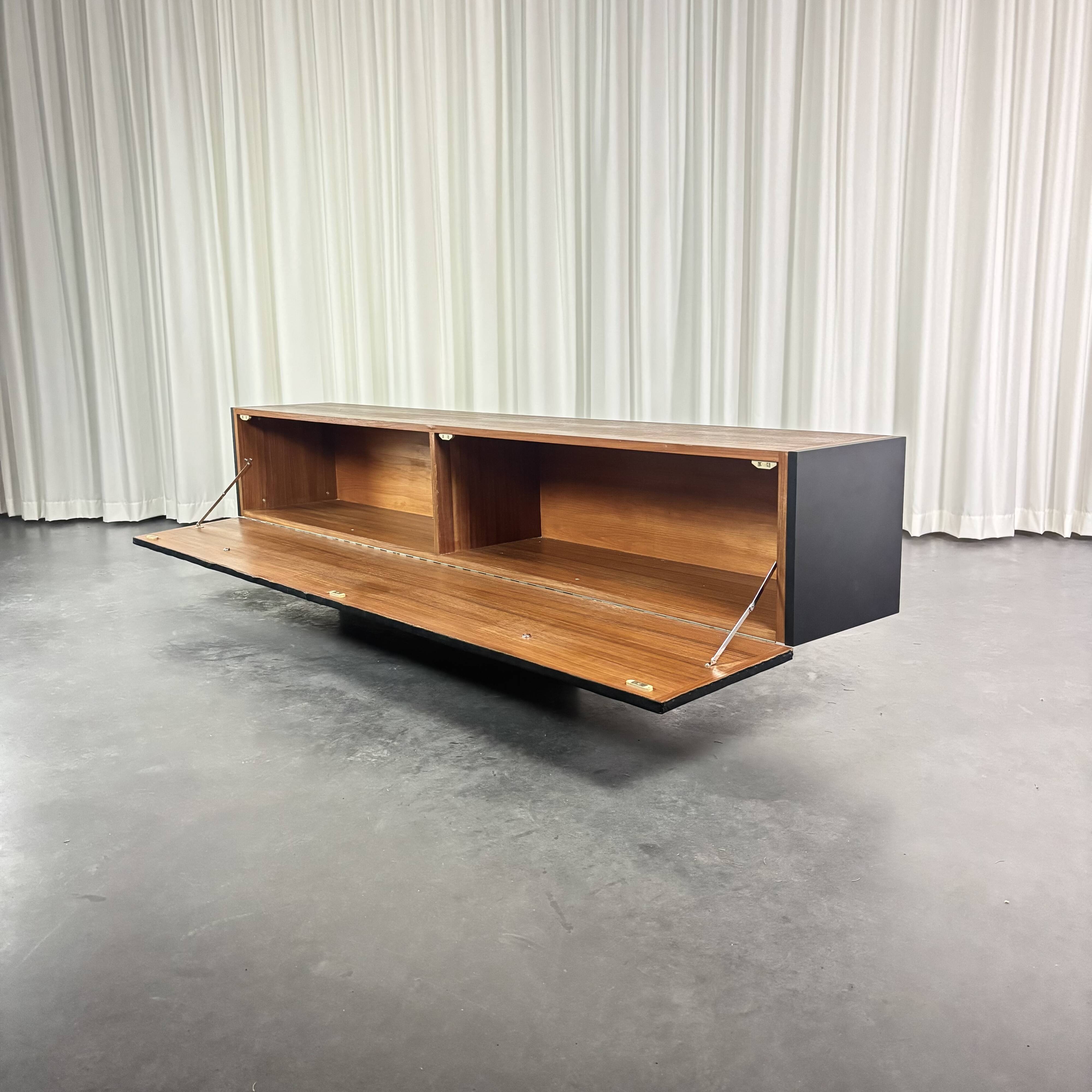 Modernist lowboard, faux leather, wood and stainless steel, 1960.