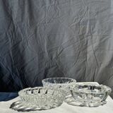 Circular glass ashtray with stylized petal patterns