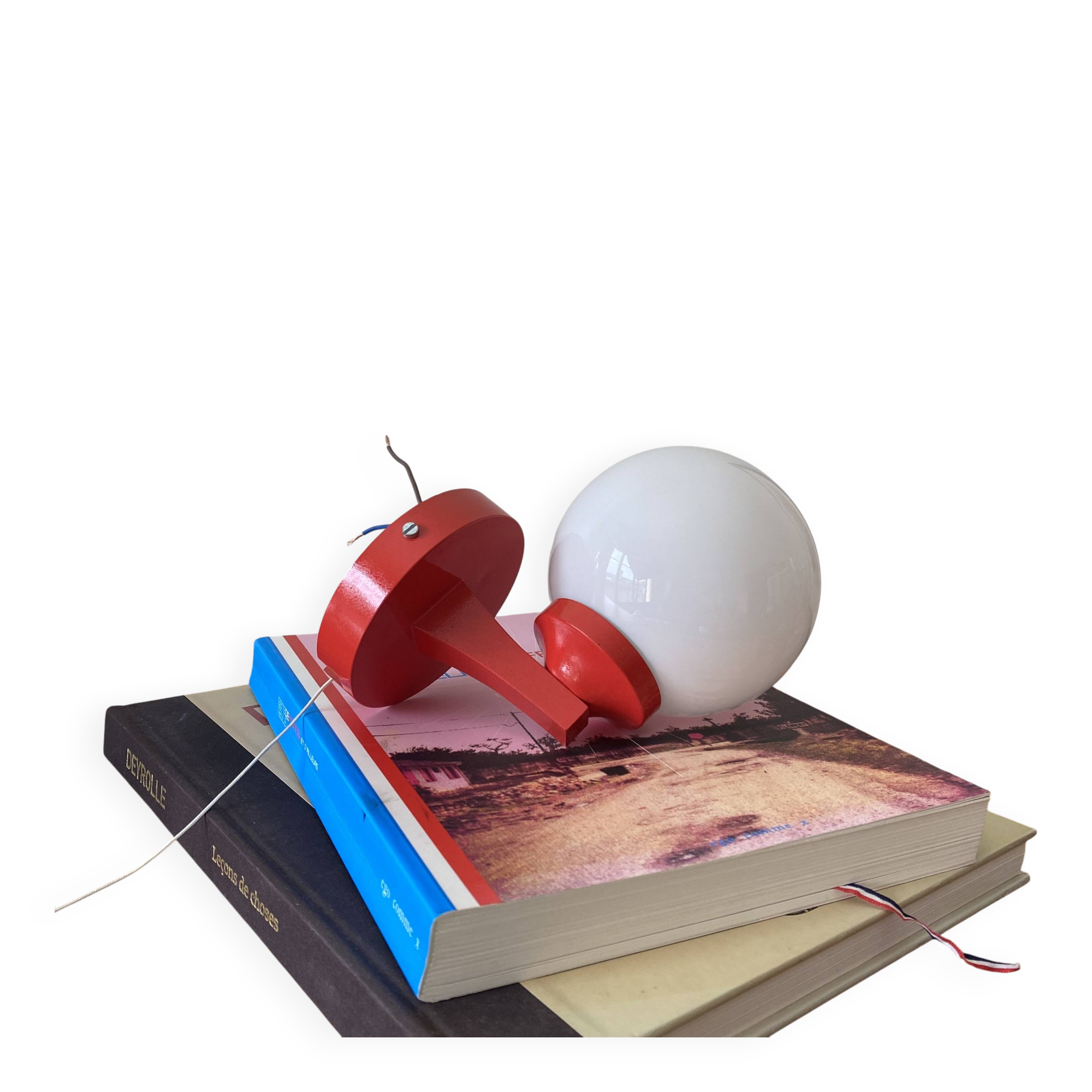 Red plastic wall light with a white opaline glass globe.