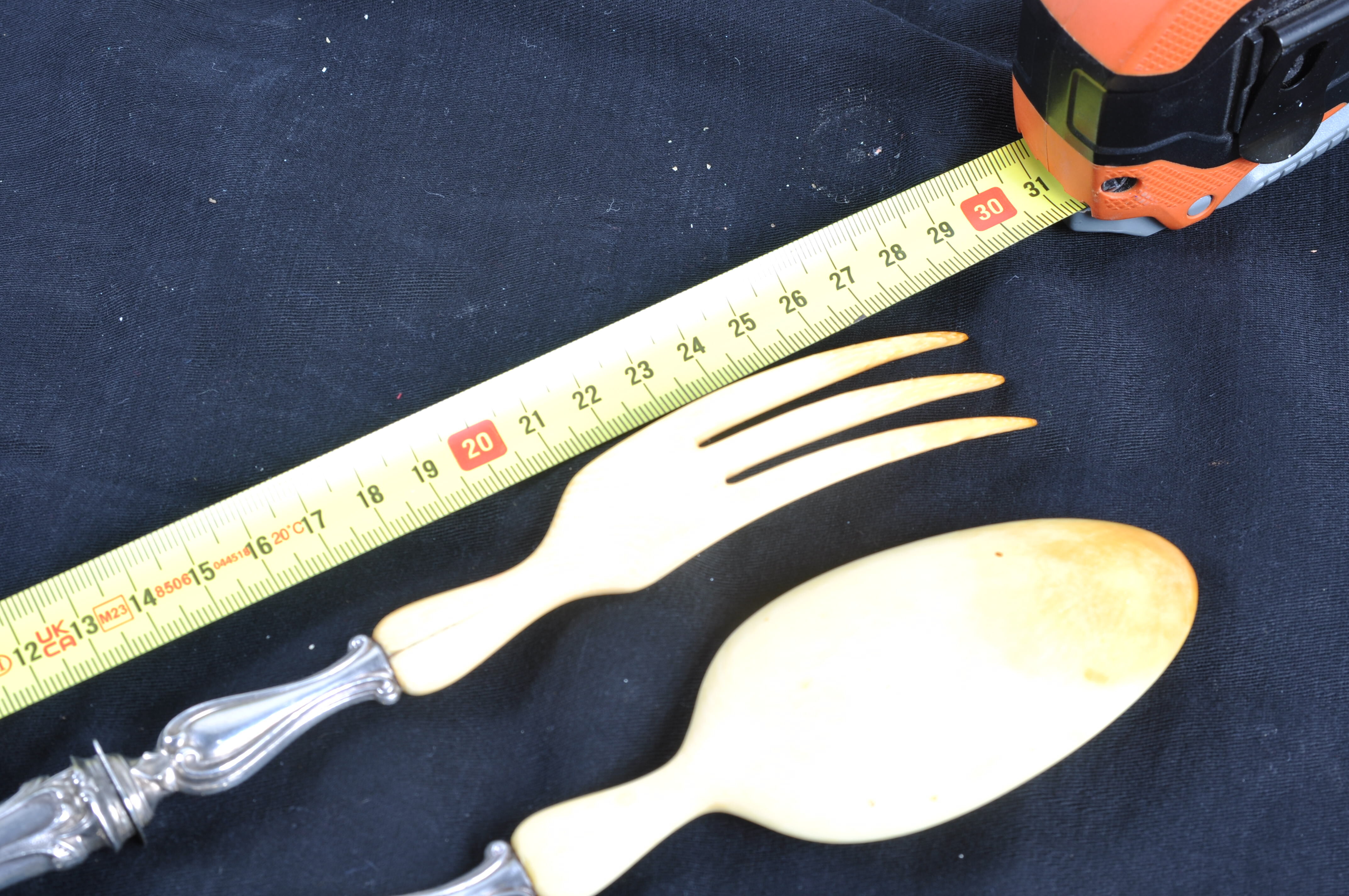 Salad serving set in antique ivory, silver-plated handle.
