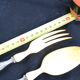 Salad serving set in antique ivory, silver-plated handle.