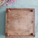 Antique earthenware and wood trivet