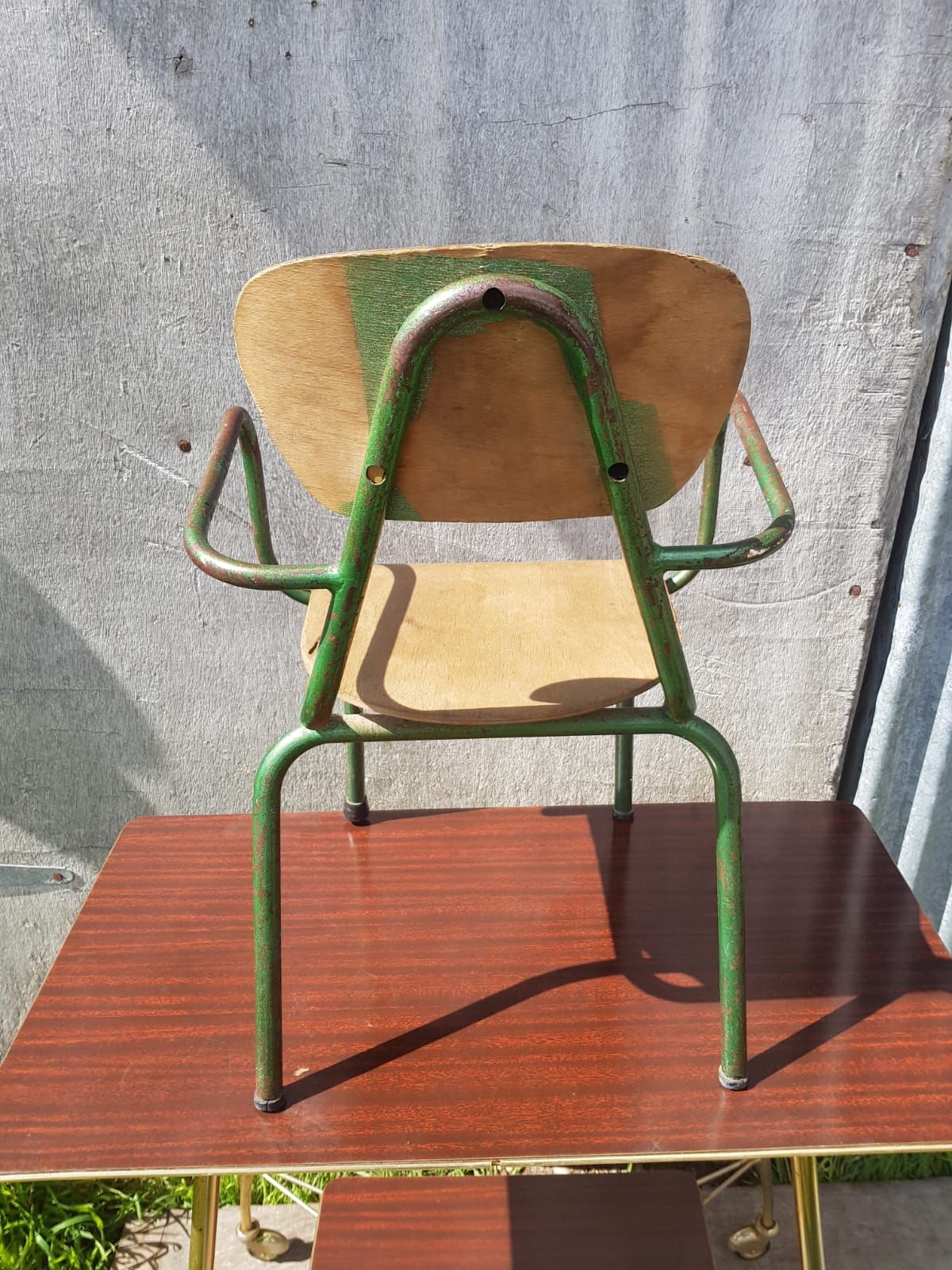 Former green metal child chair