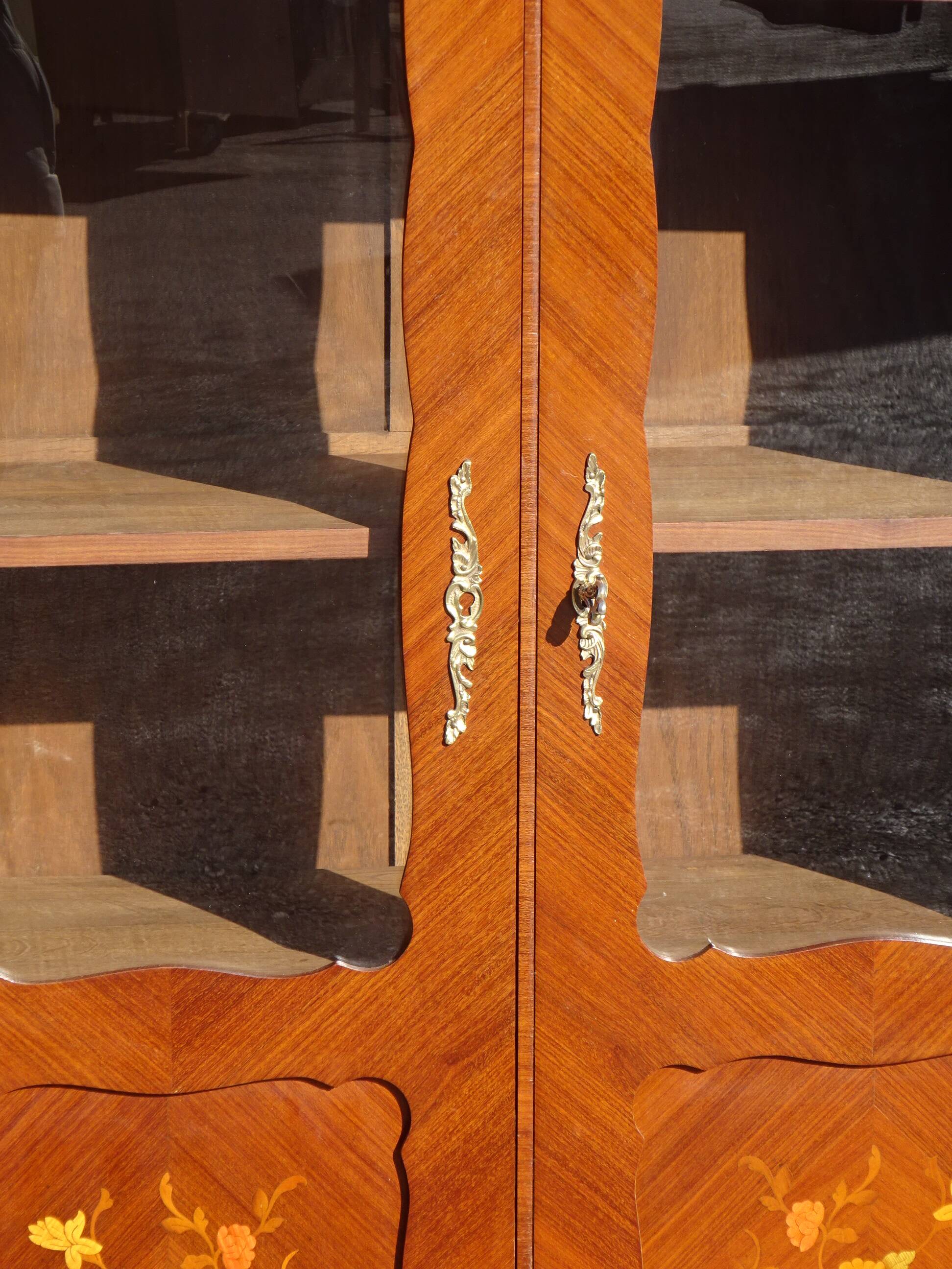 Glass library with rosewood marquetry in the Louis XV style.