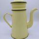 Old coffee maker in pastel yellow and black enamelled sheet metal