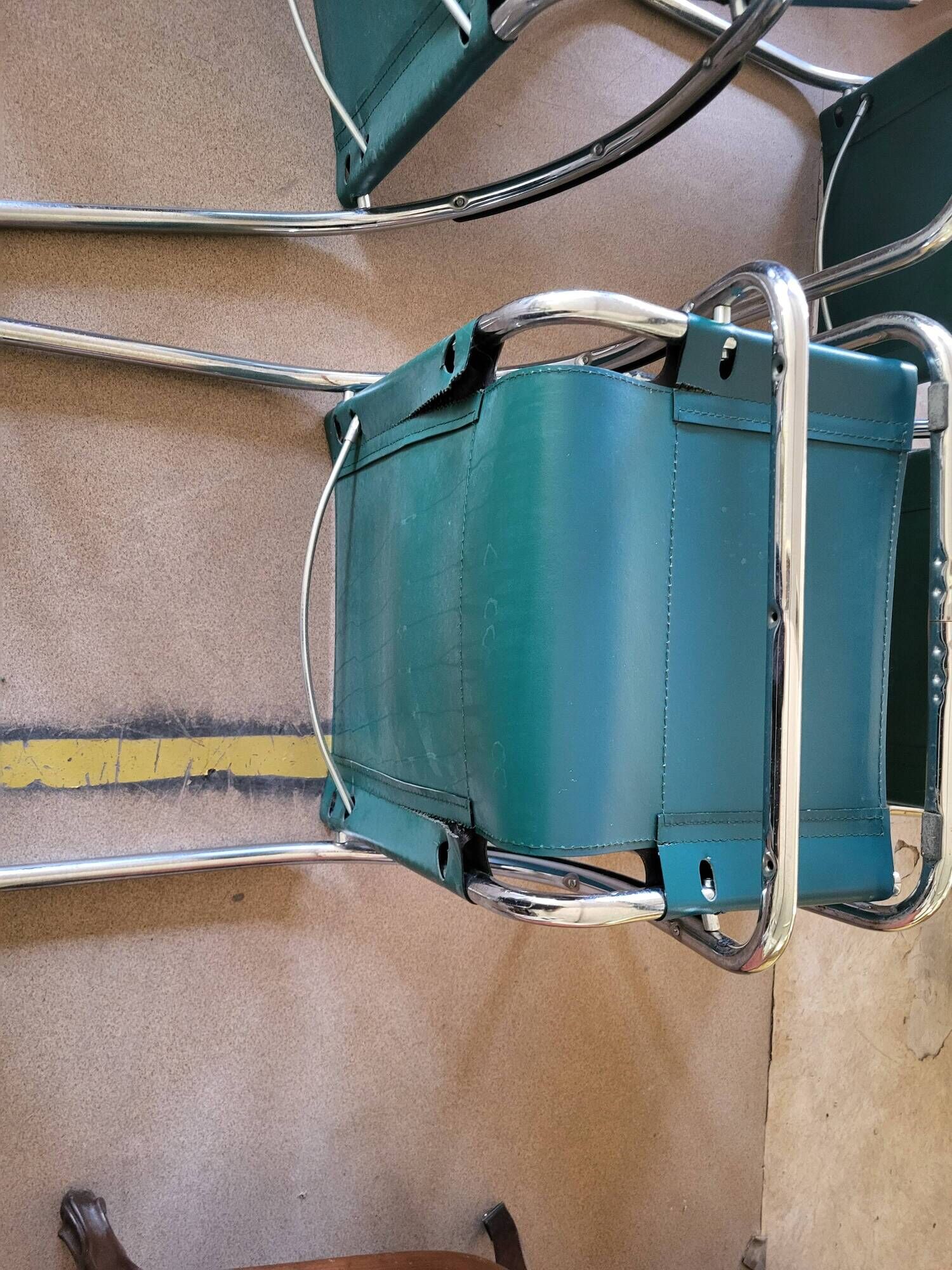 4 vintage Italian armchairs in green leather and chrome metal.