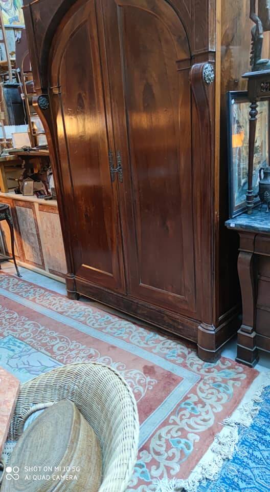 A walnut wardrobe with marquetry and boxwood stringing, dating from the Consulate period, circa 1810.