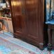 A walnut wardrobe with marquetry and boxwood stringing, dating from the Consulate period, circa 1810.