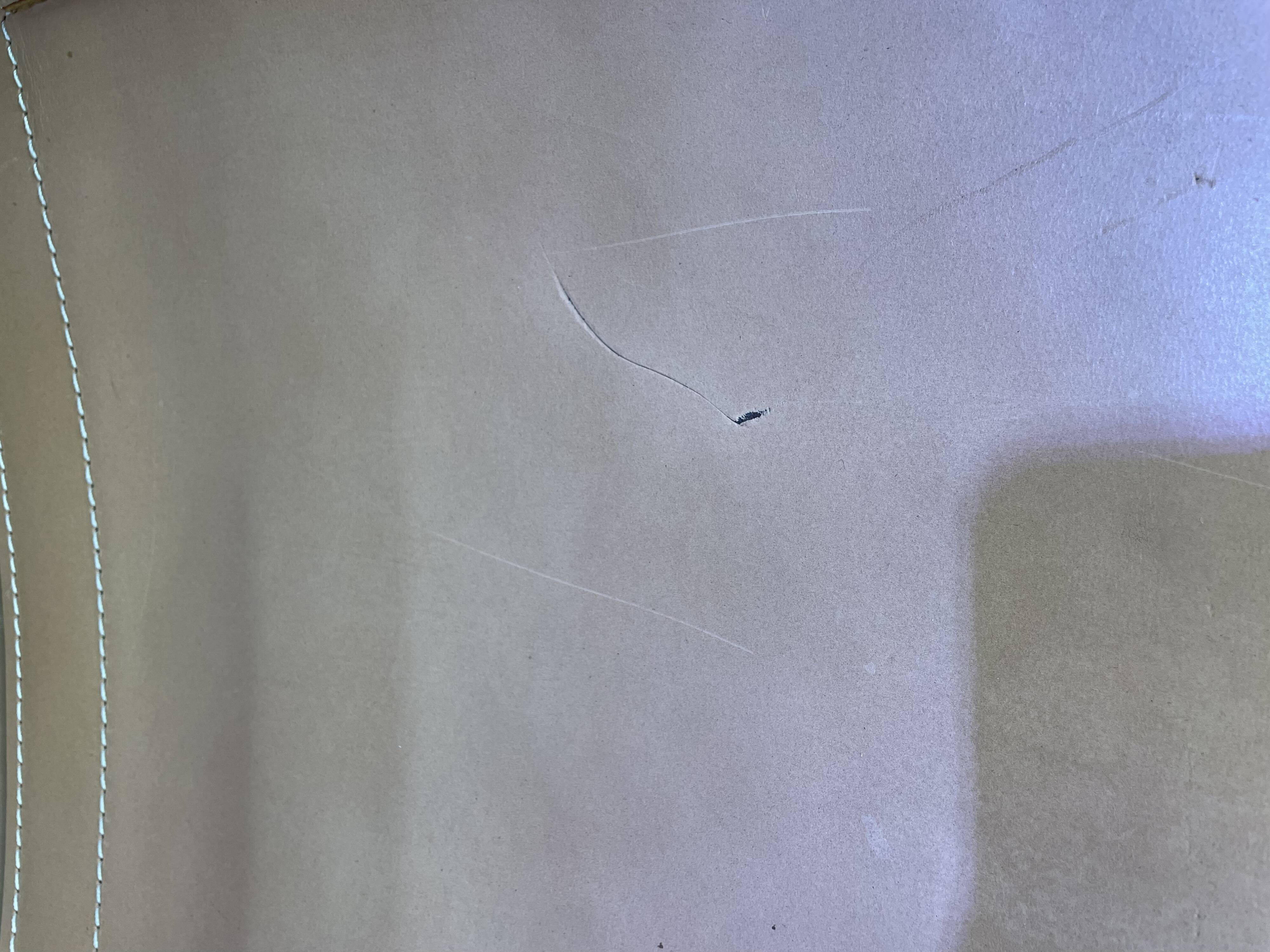 Colonial style leather armchair and ottoman