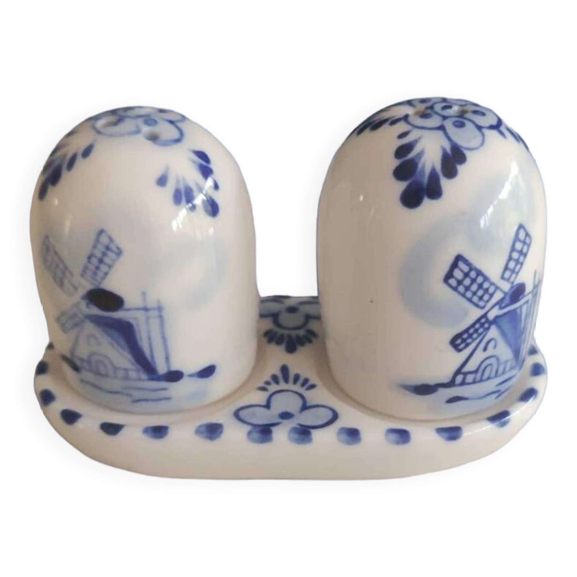 Mini salt and pepper shakers in ceramic with illustrations of Dutch windmills and blue flowers.