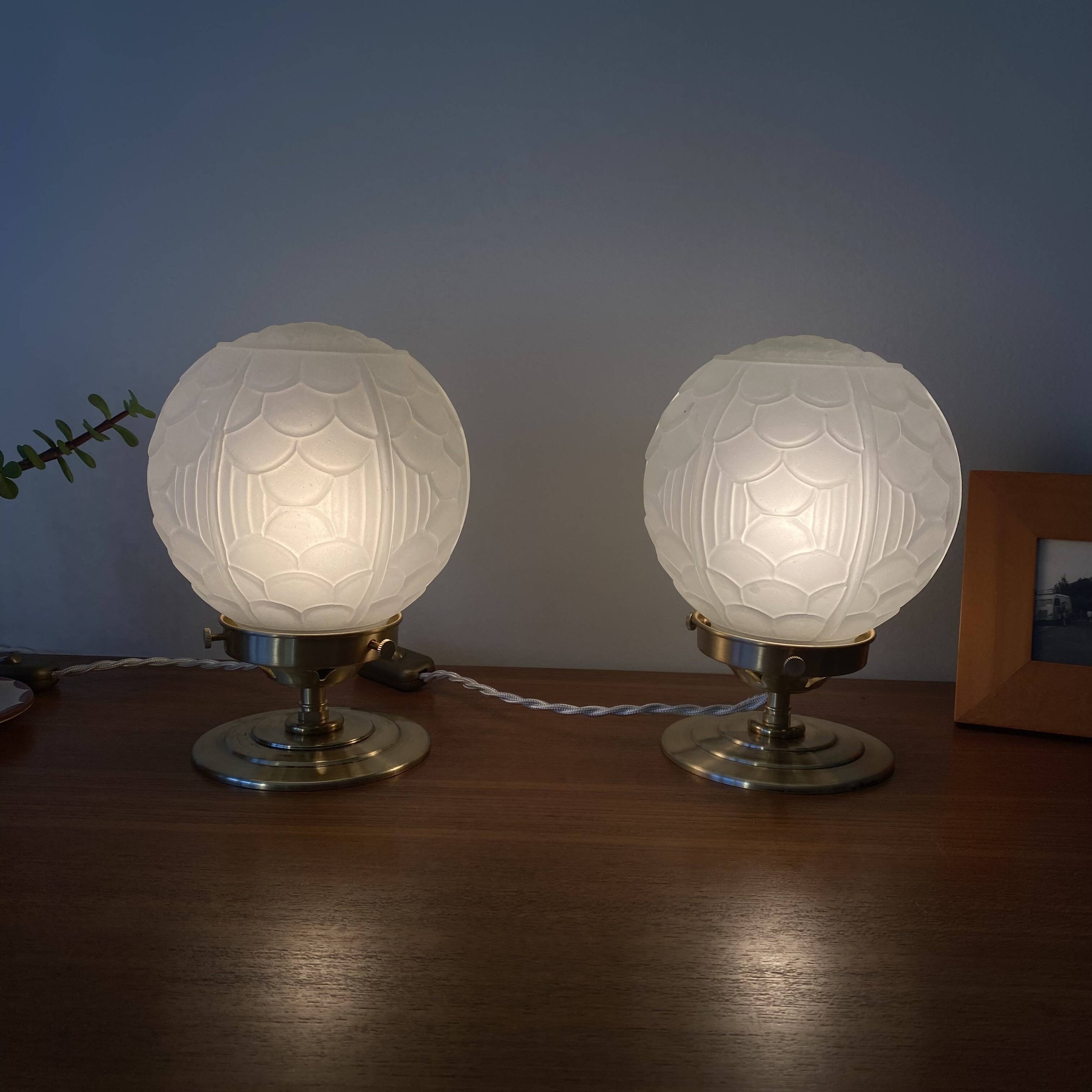 Pair of Art Deco glass globe table lamps with brass base.