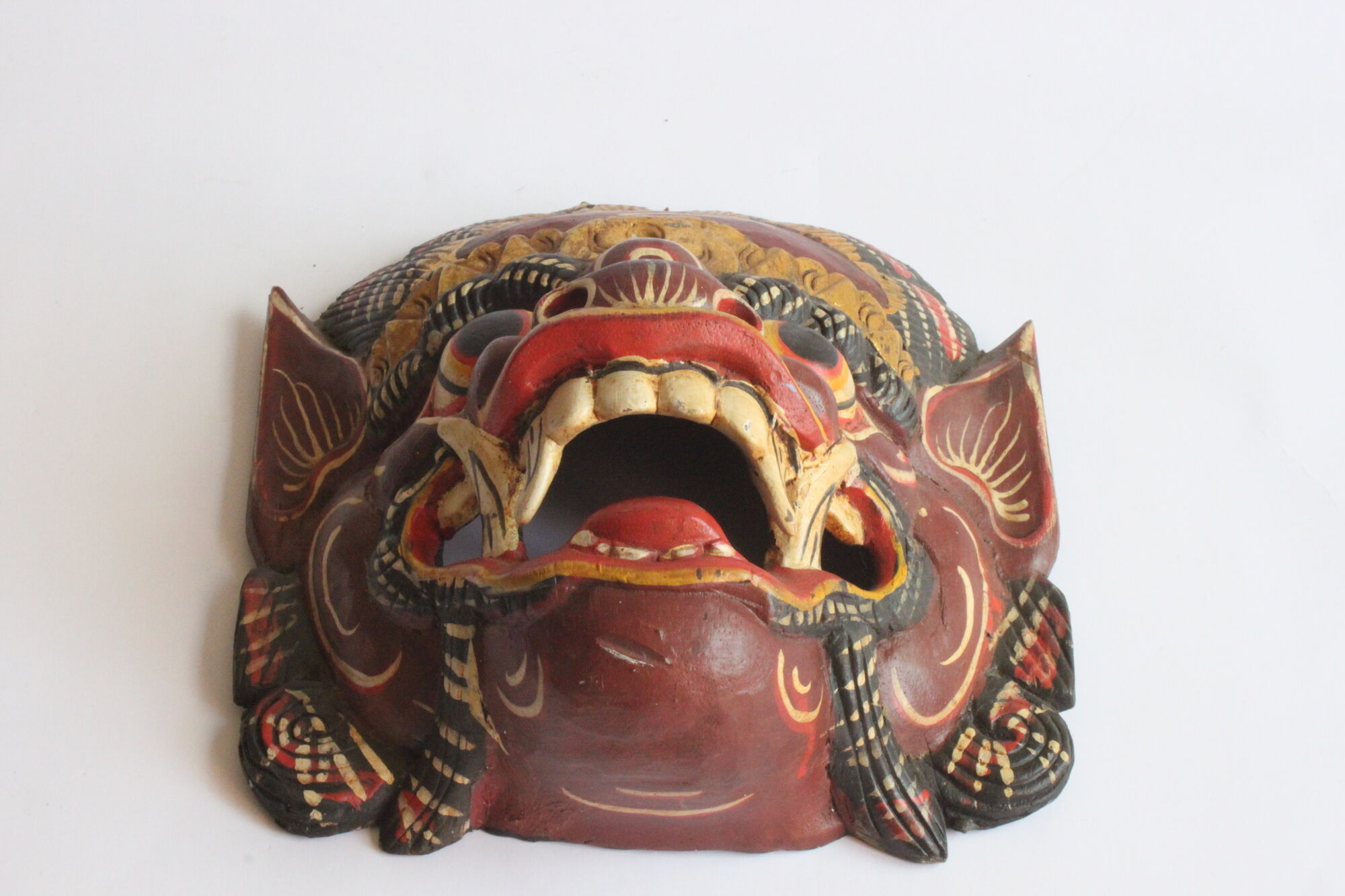 Two polychrome painted and gold leaf gilded Barong dance masks from Bali, Indonesia.