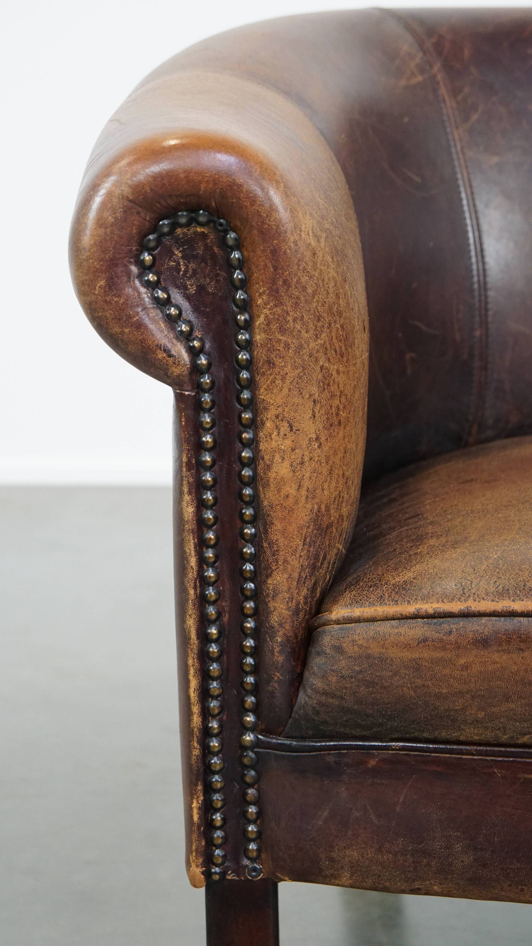 Sheep leather club chair finished with decorative nails