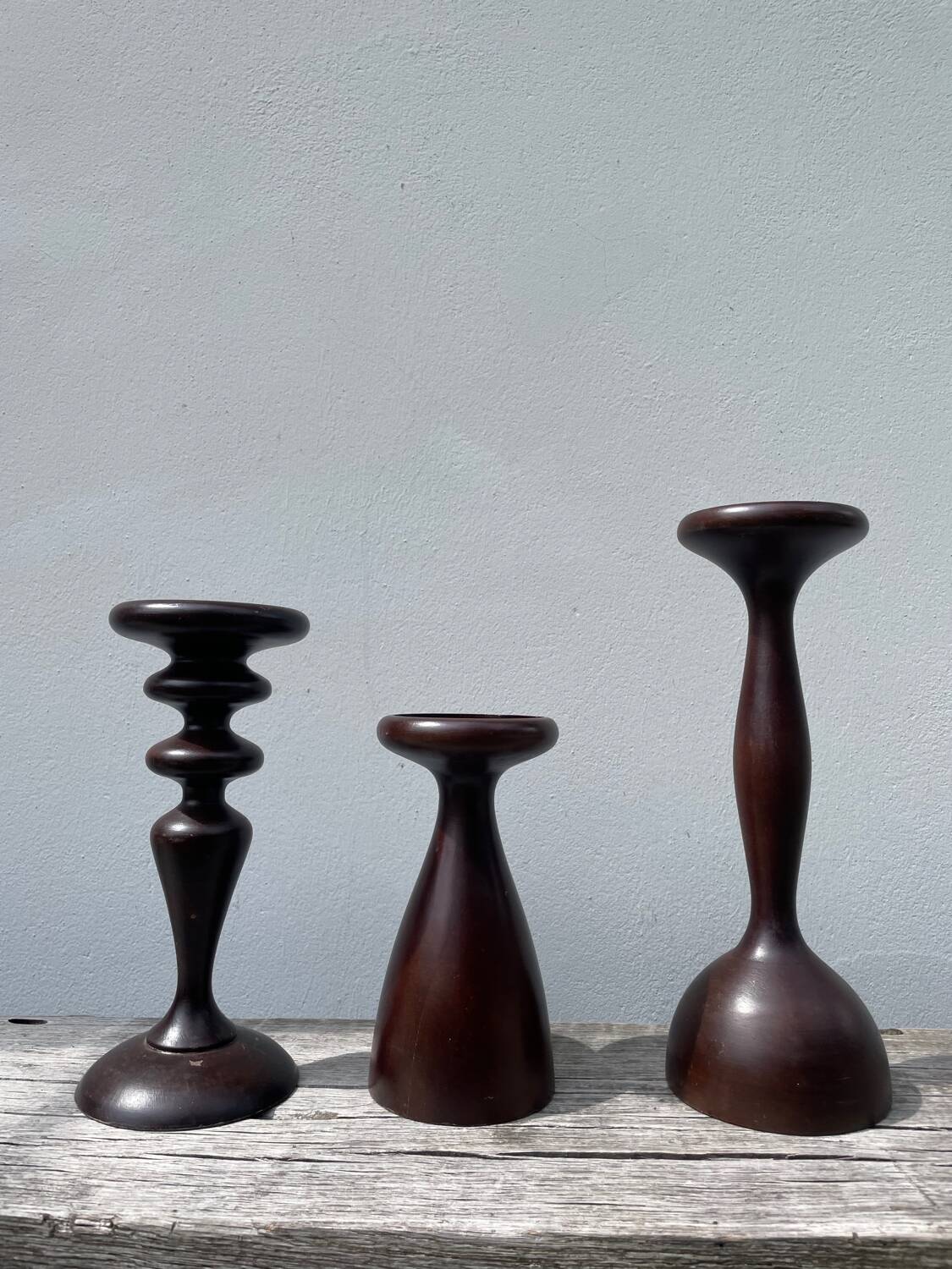 Trio of large turned wooden candlesticks