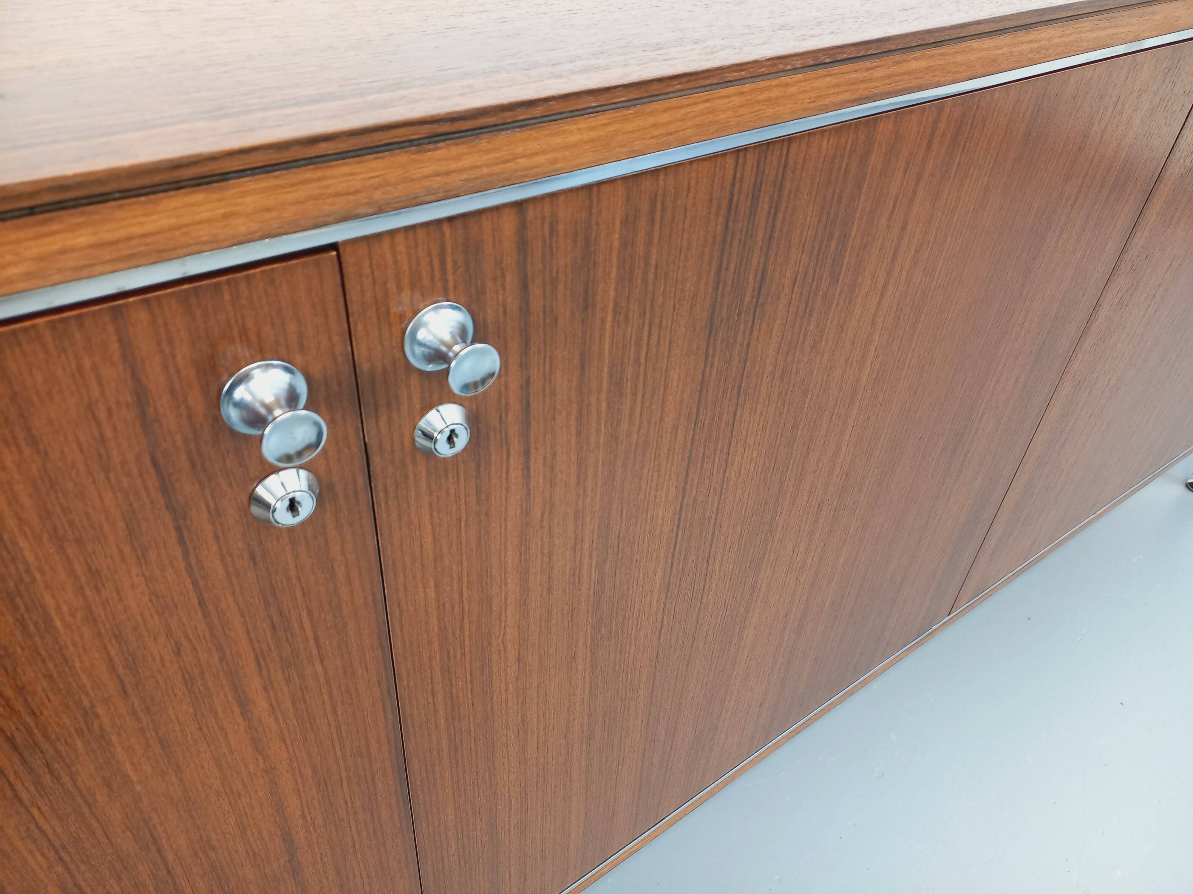 Vintage modernist enfilade in rosewood and chrome metal from the 60s and 70s.