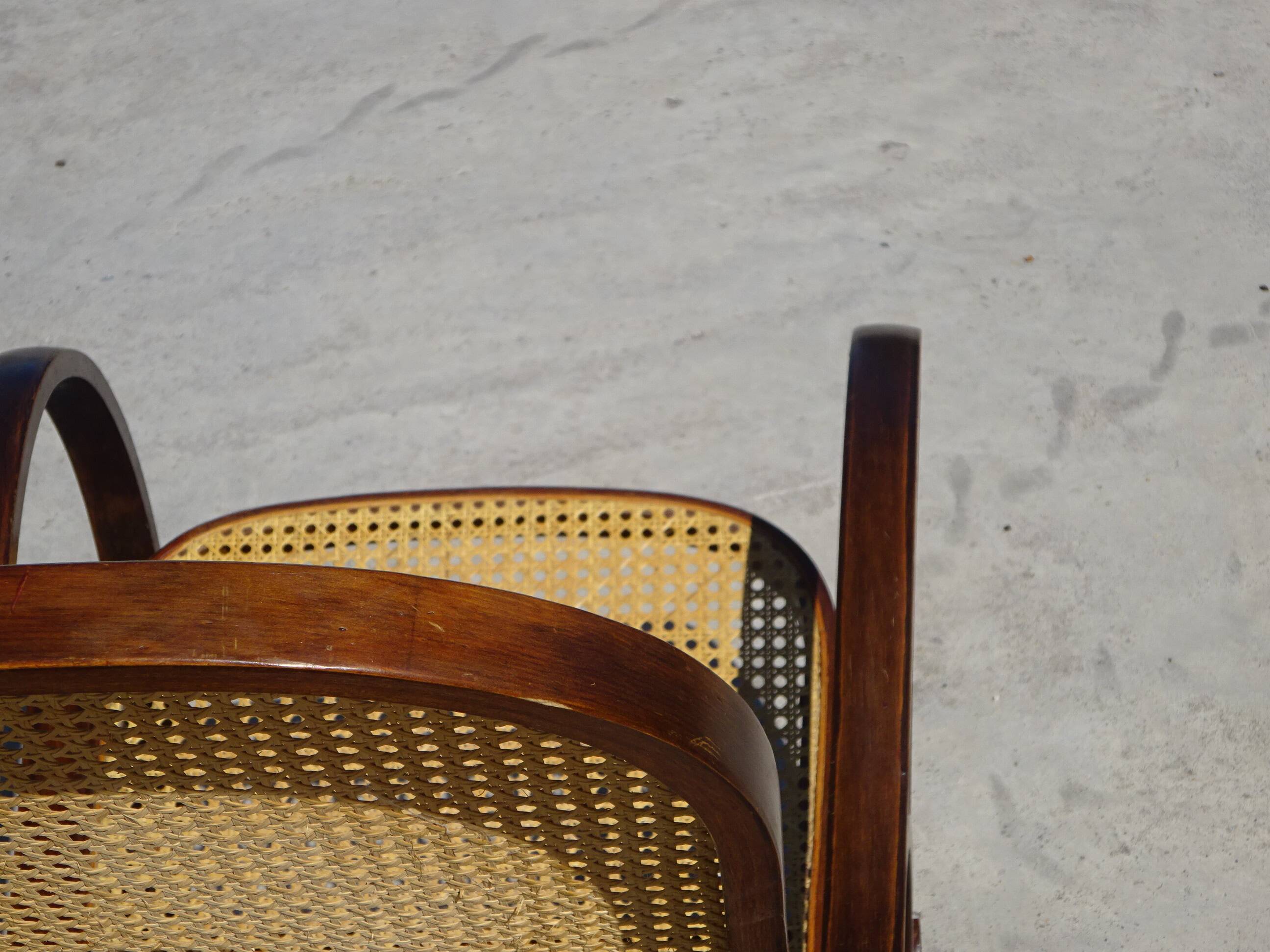 Vintage wooden rocking chair with caning