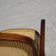 Vintage wooden rocking chair with caning