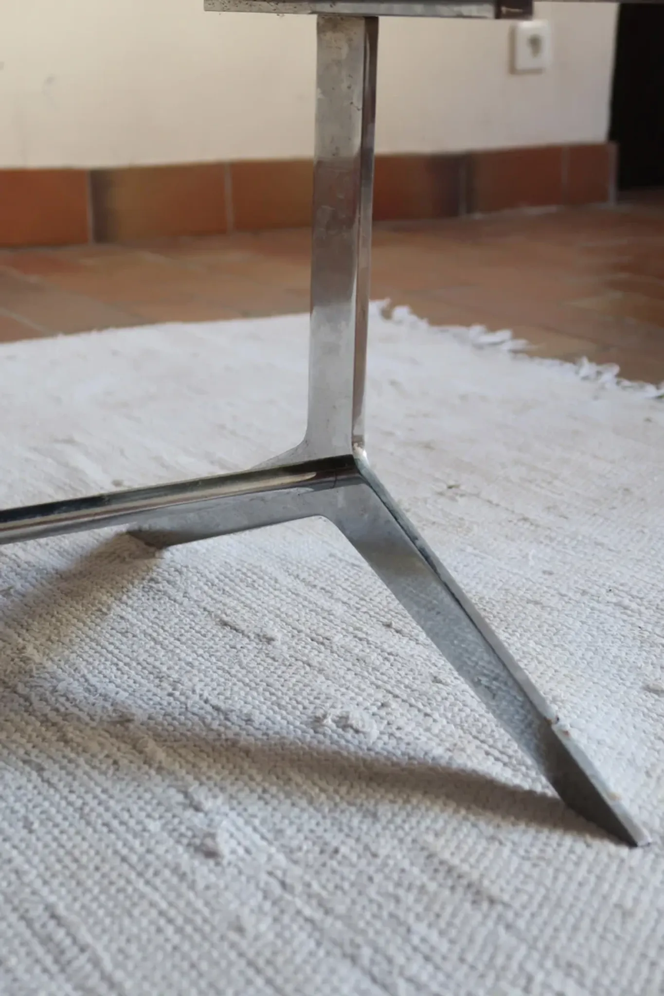 70s design coffee table with a black top and steel legs.