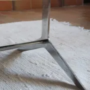 70s design coffee table with a black top and steel legs.
