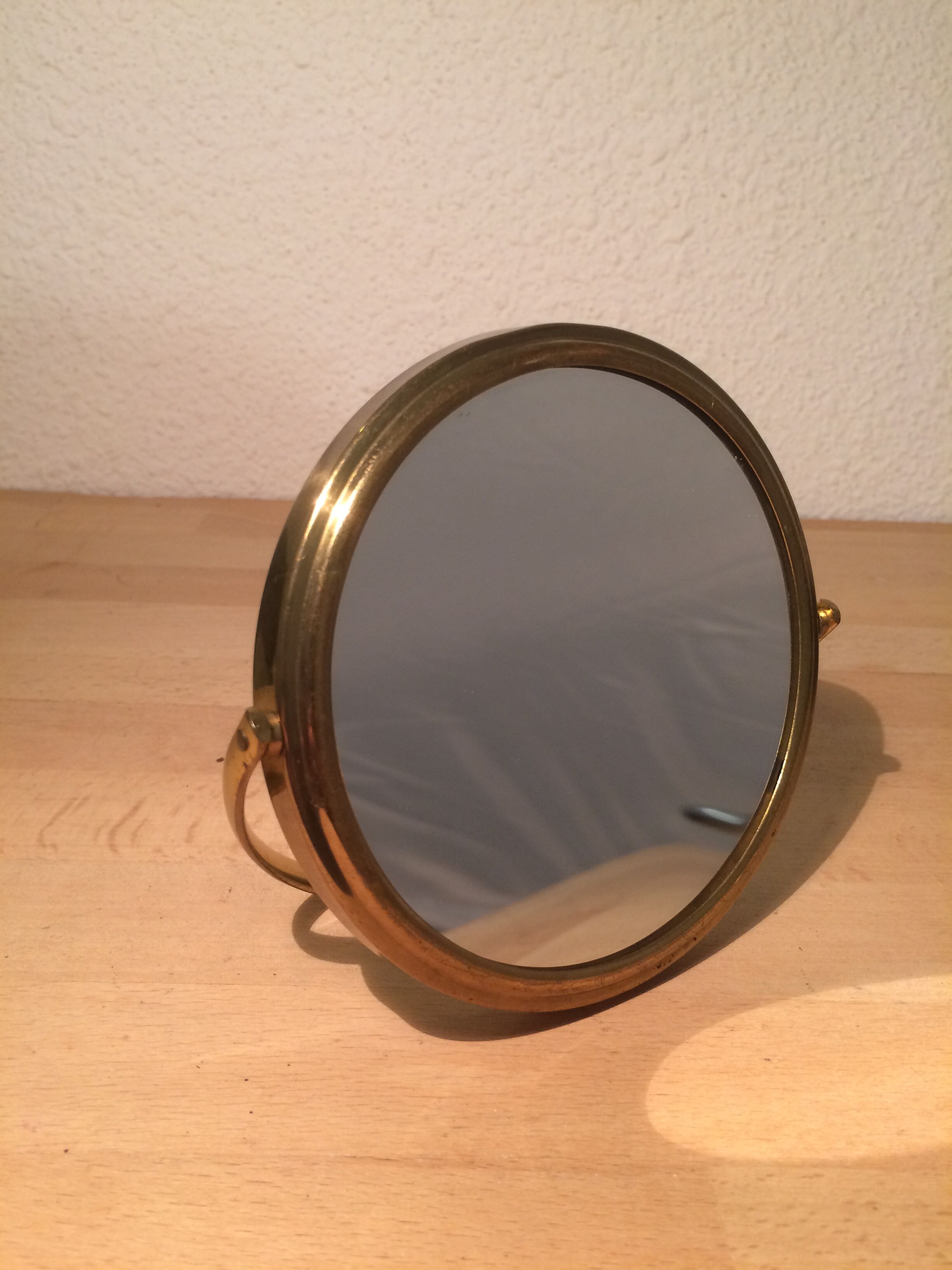 Vintage magnifiing gold round barber mirror