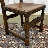 High-backed chair from the early 20th century in oak and leather